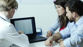 A married speaking to a fertility doctor in his office