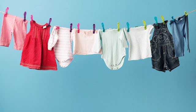 Children's clothes in various colors drying on a rack