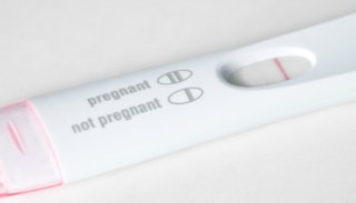 A white-and-pink negative pregnancy test representing dealing with infertility