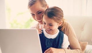 A woman who is navigating life as a traveling working mom holding her daughter in their lap while th...