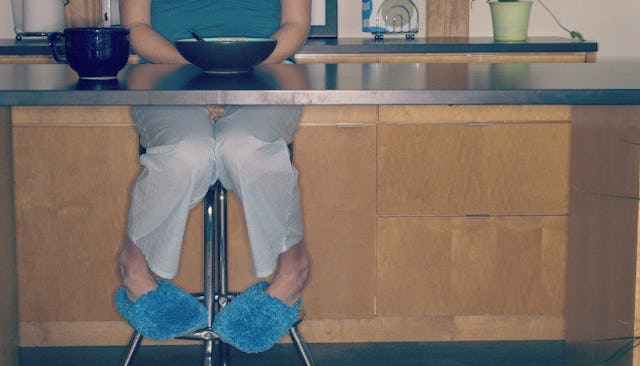 Woman sitting at the kitchen table alone