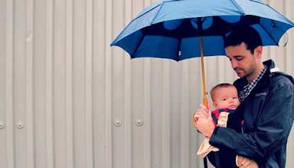 Dad and his baby under an umbrella