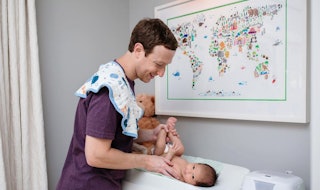 Mark Zuckerberg changing his baby's diaper
