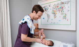 Mark Zuckerberg changing his baby's diaper