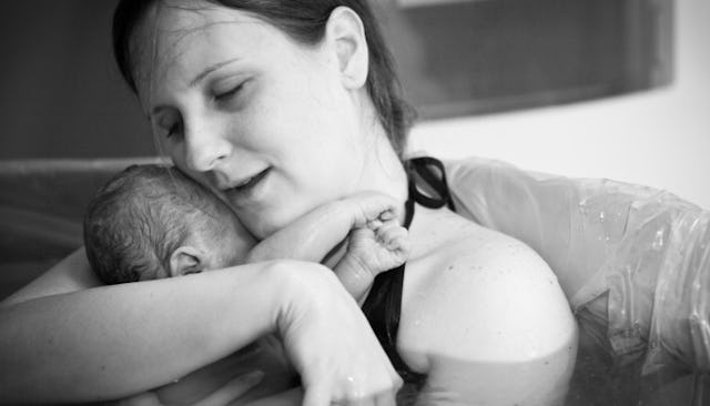 A mom hugging her newborn after giving birth at home