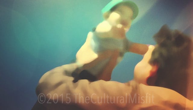A blurred dad holding his baby up during the first year as a parent
