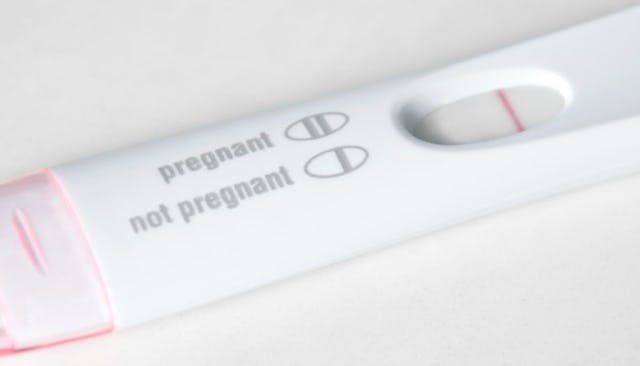 A close-up of a white-pink negative pregnancy test