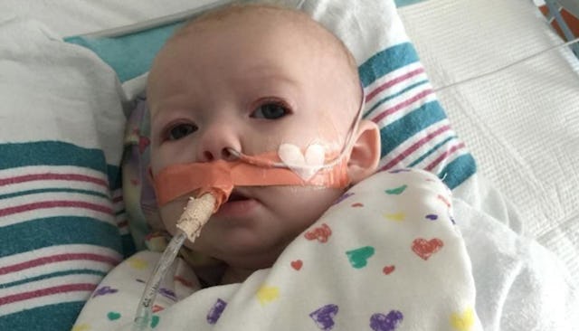 A young baby girl suffering from a highly contagious respiratory infection due to people with non-wa...