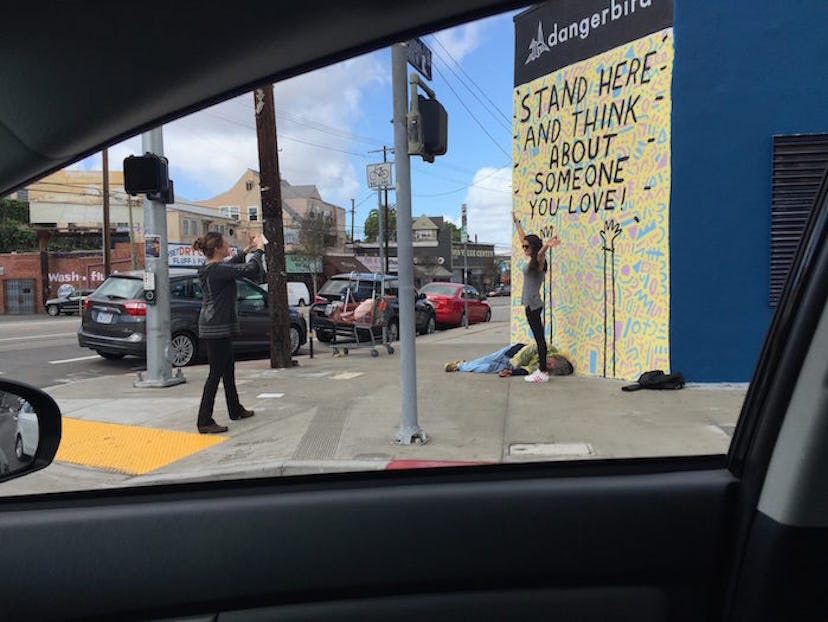 girl-poses-in-front-of-homeless-man