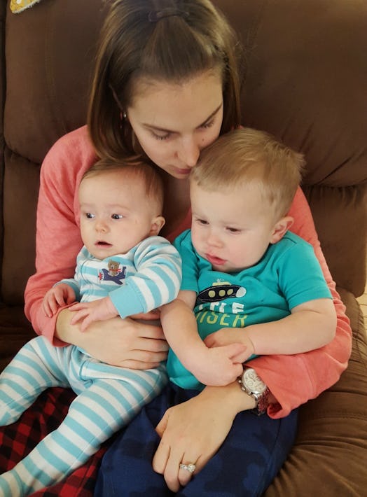 Melissa Mowry sitting while holding her baby and her toddler in her lap