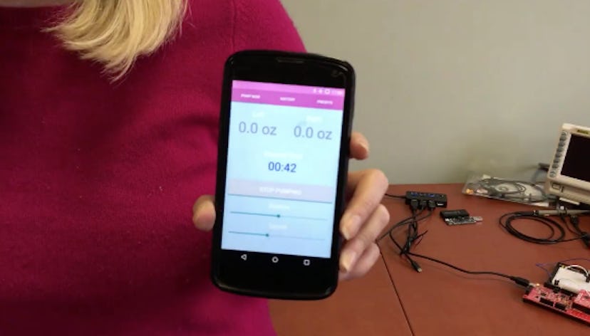 Woman showing a mobile app that tracks how much you pumped and how long it took