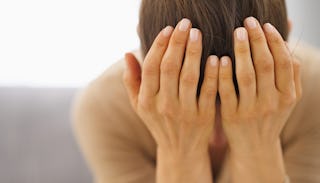 Woman covering her head with her arms as she’s worried about getting a divorce