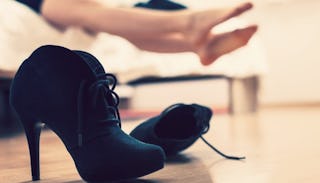 Female black high heels thrown on the floor by a woman who was on a date after being married