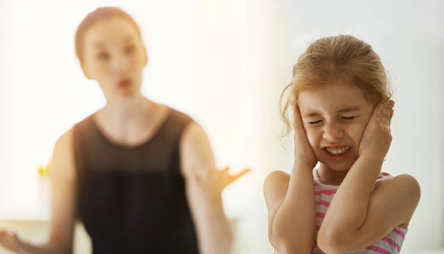 A mom that reached her limit yelling at her daughter while the daughter holds her hands on ears