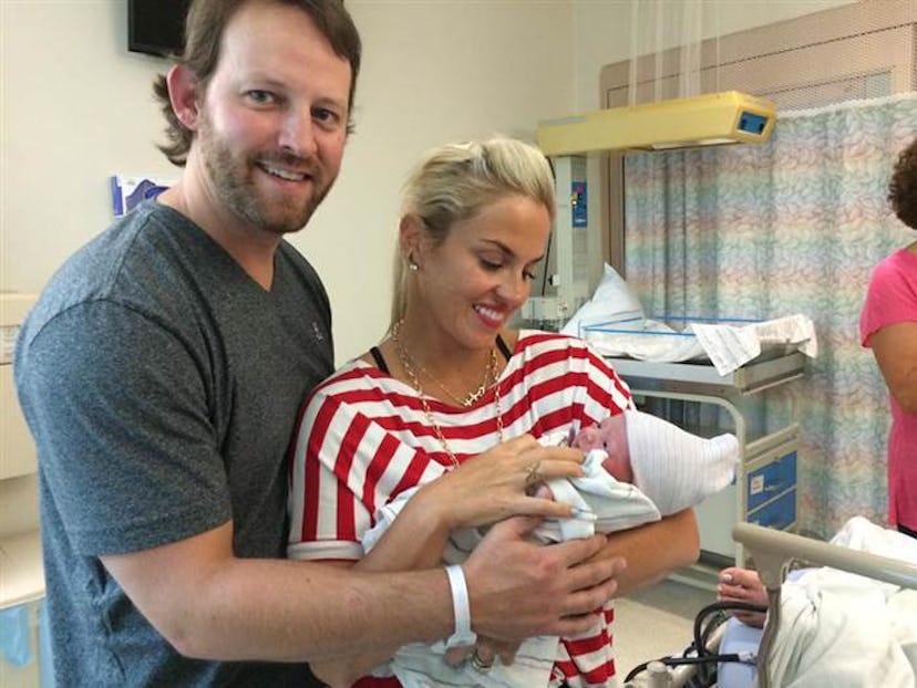 Mother and father holding their baby in the hospital 