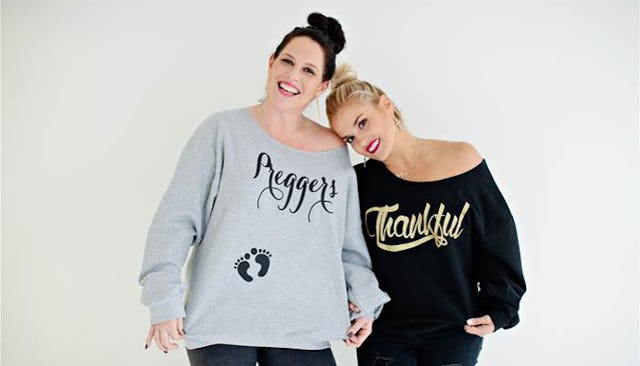 Two best friends wearing hoodies that say "preggers" and "thankful"