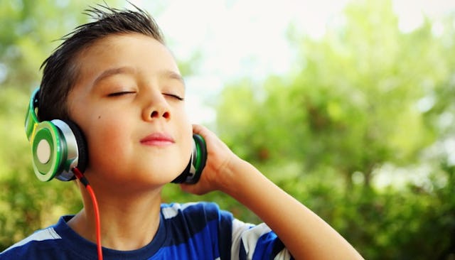 A boy listening to pop music on his earphones