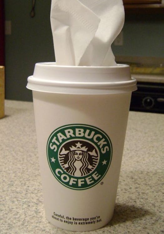 Unused small to-go Starbucks coffee cup filled with tissues, ready to use
