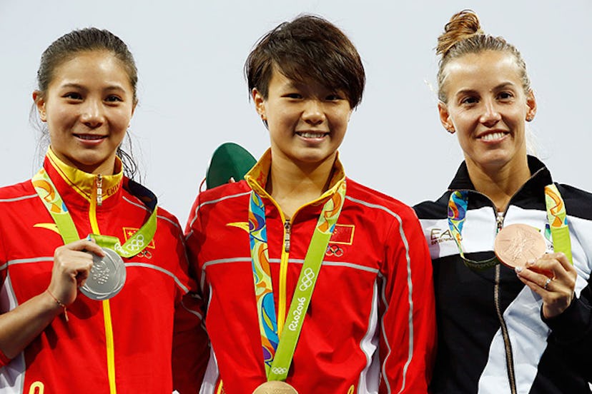 He Zi on the left with her silver medal. Image via Clive Rose/Getty Images.