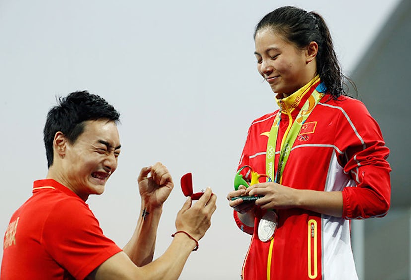 Qin Kai signaling to the crowd that Zi said yes. Image via Clive Rose/Getty Images.