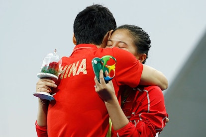 Celebratory hug. Image via Clive Rose/Getty Images.