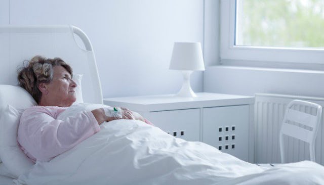 Estranged mother lying on a hospital bed 