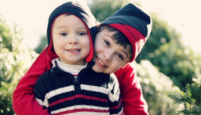 A boy hugging his autistic brother during Christmas time