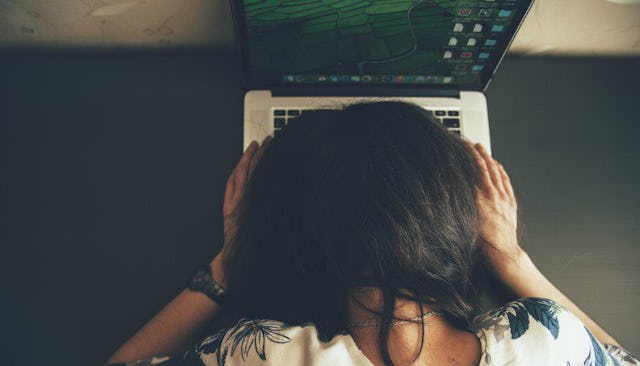 A tired lady sleeping on her laptop