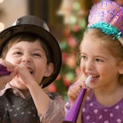 A small boy and girl celebrating New Year’s Eve at home 