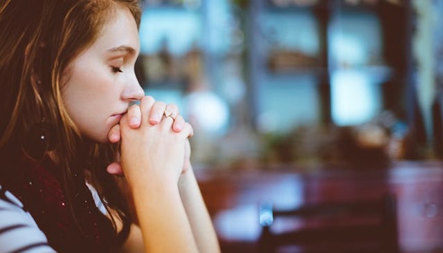 A woman who recently had a miscarriage sitting with closed eyes whose Pro-Choice beliefs were reaffi...