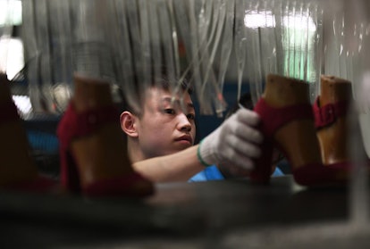 This photo taken on September 14, 2016 shows a worker on a production line at the Huajian shoe facto...