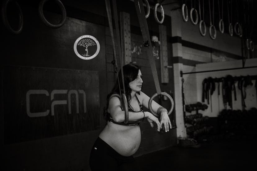 A fit mom leaning on the training equipment inside the gym