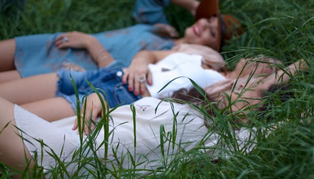 Four girls having fun in the grass during a girls' weekend