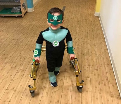 Rachelle Chase's son dressed as the Green Lantern with a device helping him walk 