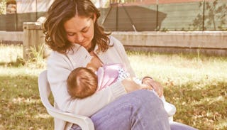 A young mother holding and breastfeeding her baby 