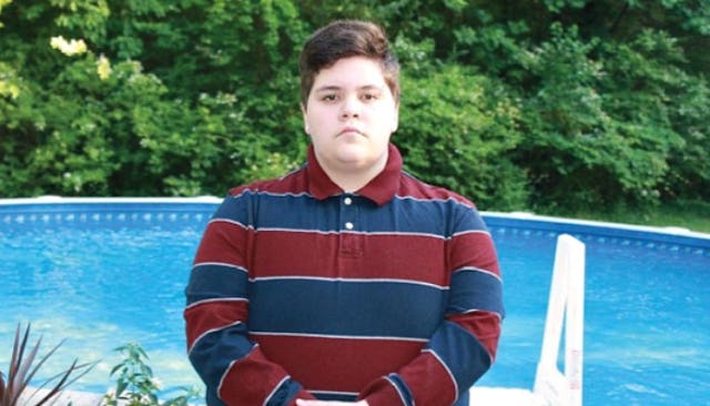 Gavin Grimm, a trans kid in Trump's America in a blue-red polo shirt posing in front of a swimming p...