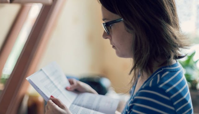 A SAHM looking through her student loan debt documentation 