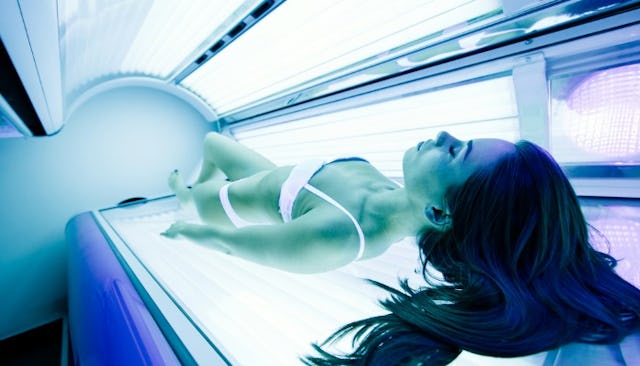 A woman in a tanning bed