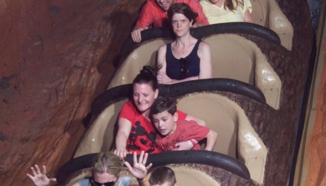 People screaming on a 'Splash Mountain' rollercoaster and Jordan Alexander crossing her hands with a...