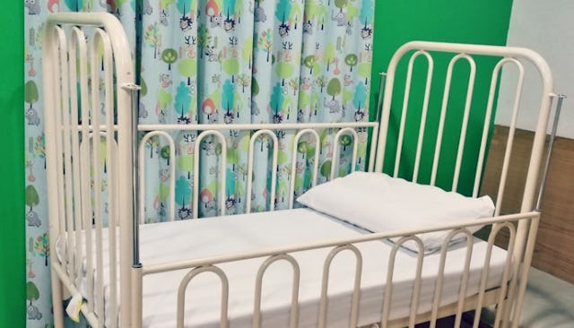 A white toddler bed in an adoption center