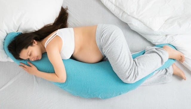 pregnant woman, pregnant woman hugging a pregnancy pillow, pregnant woman hugging body pillow, pregn...