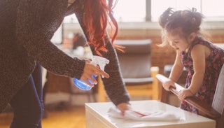 Mother and daughter cleaning a living room table together
