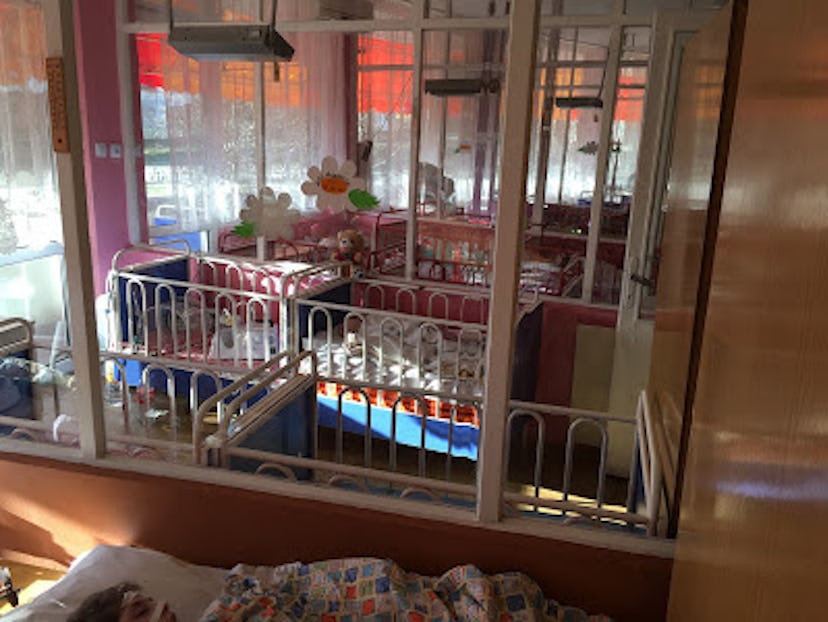 A baby adoption center room with various toddler beds and cribs