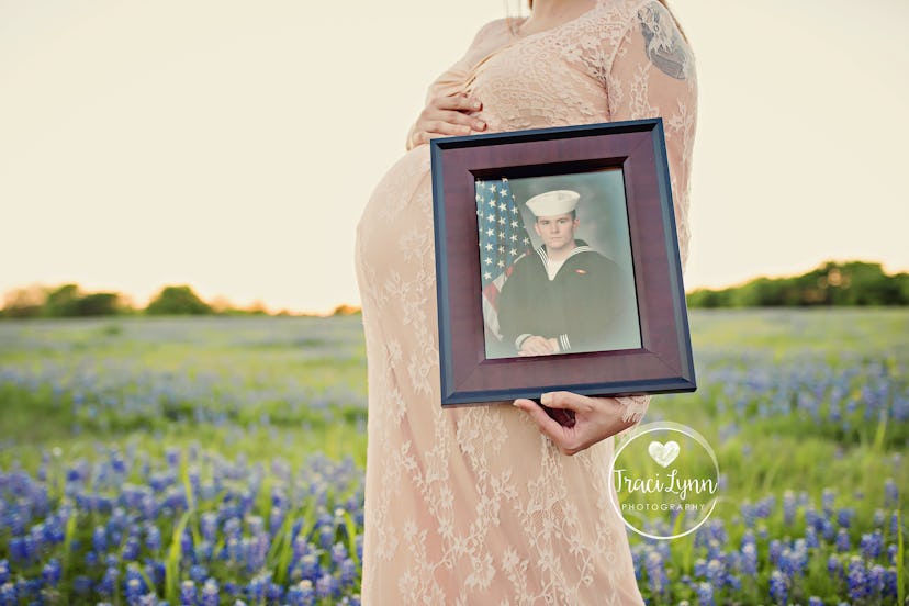 A pregnant woman holding her belly and a picture of her deployed soldier husband.