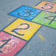 A colorful hopscotch grid drawn on a school playground