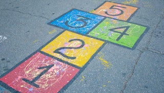 A colorful hopscotch grid drawn on a school playground