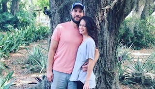 Couple Hugging In Front Of A Tree