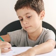 A boy with ADHD writing his homework 