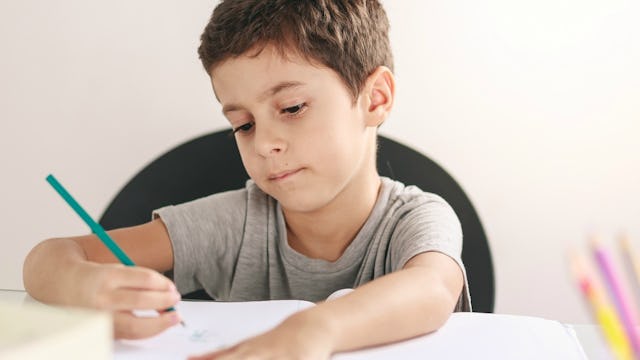 A boy with ADHD writing his homework