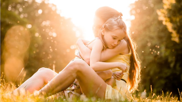 A young mother calming her anxious child by holding her